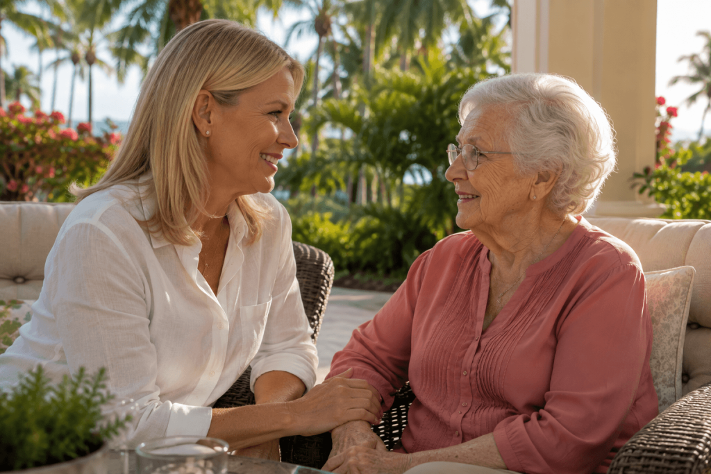 Adult daughter talking with her senior mother on a shaded outdoor patio in Royal Palm Beach, FL